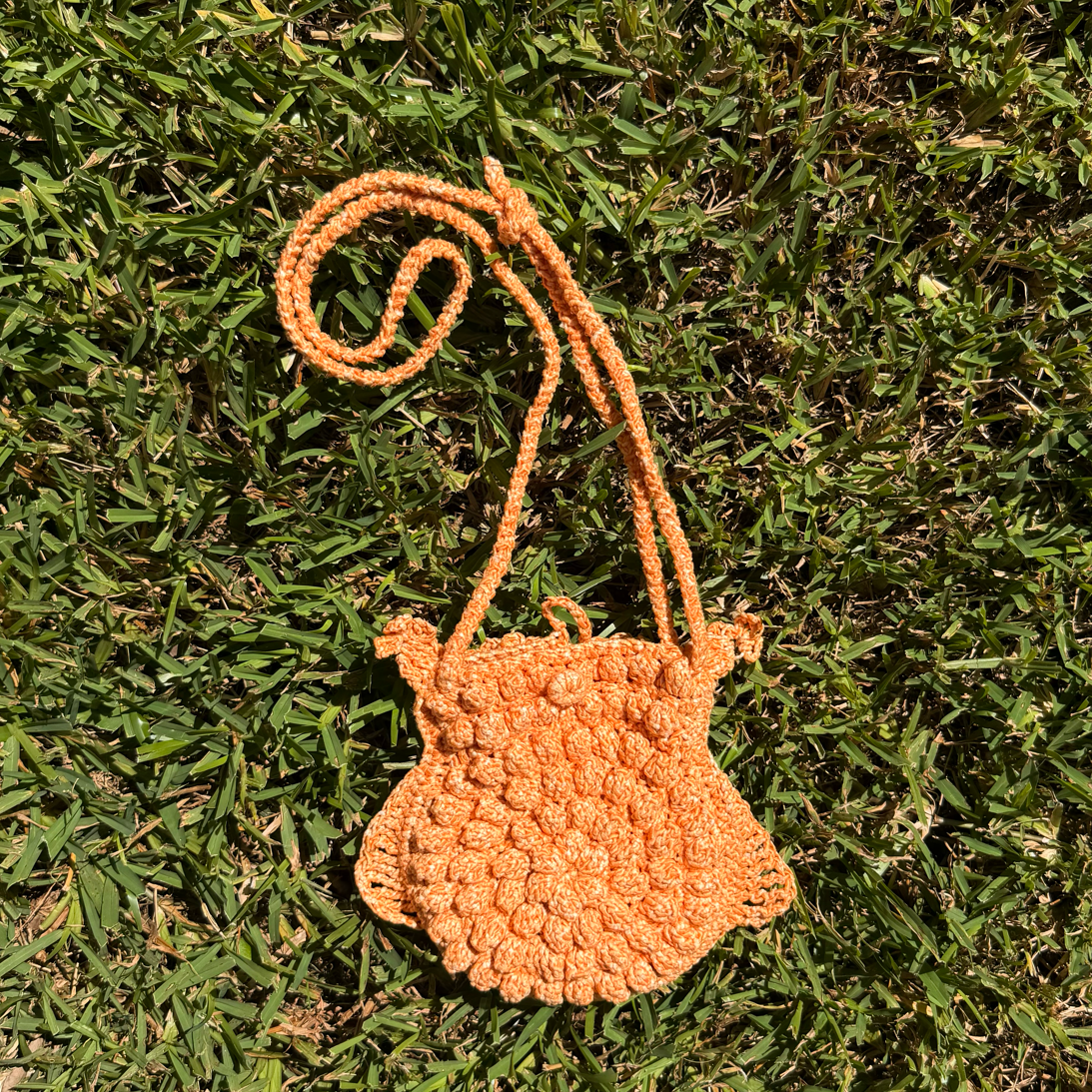 Small orange crocheted bag - back